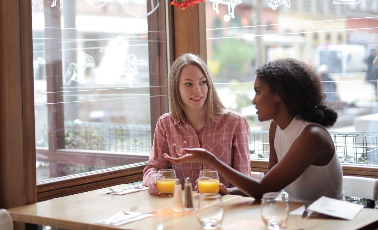 Two people in thoughtful conversation over a table